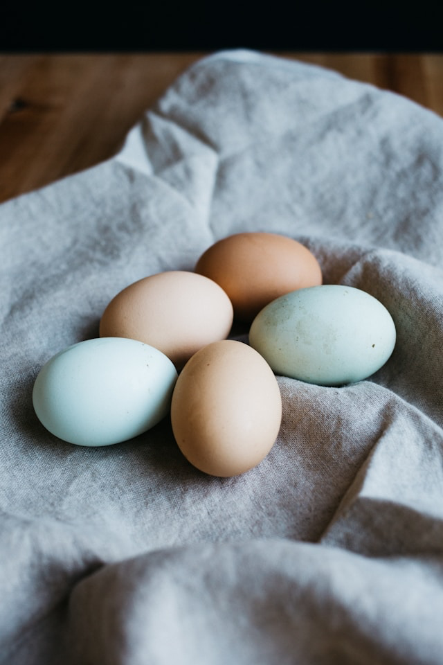 Boiled egg being peeled easily under water