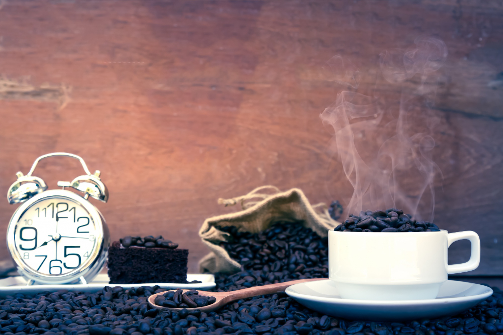 Cup Of Coffee Next To Clock Showing Late Afternoon Time
